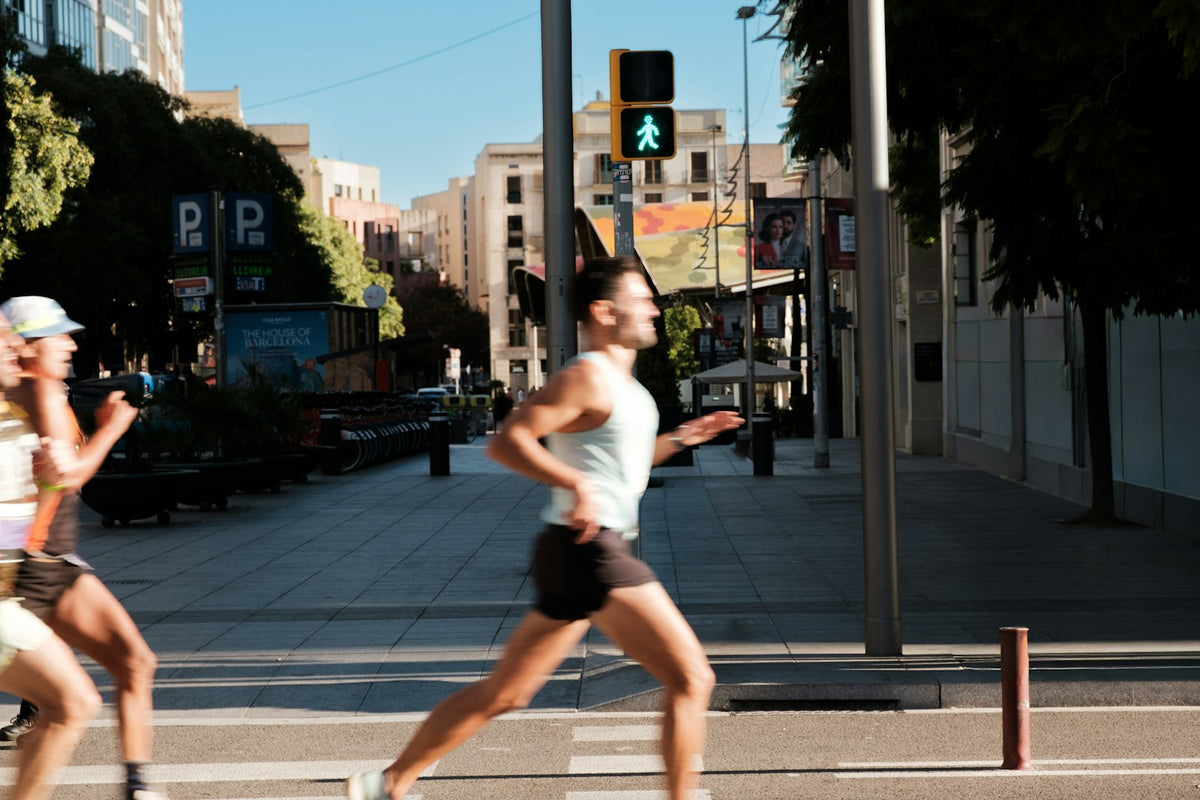 Men running down a city street in daylight